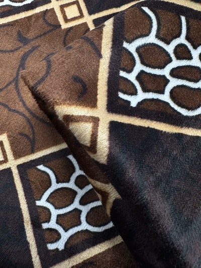 Close-up of DD Velvet - Regal Lattice by Super Cheap Fabrics: a plush, medium weight 100% polyester fabric with a brown, tan and white geometric lattice pattern and smooth finish. Width: 154cm.