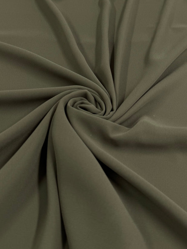 A close-up of the Hi-Multi Chiffon - Ivy Green fabric by Super Cheap Fabrics, lightweight and spiraled.