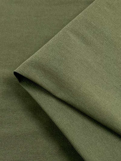 A close-up image of a piece of folded stretch Bengaline lightweight fabric in khaki from Super Cheap Fabrics. The khaki fabric appears smooth with a slightly matte texture.