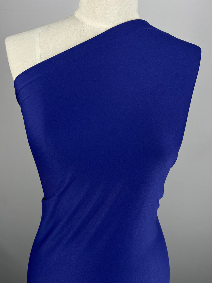 A mannequin elegantly showcases a fitted, lilac-colored dress from Super Cheap Fabrics against a neutral background.