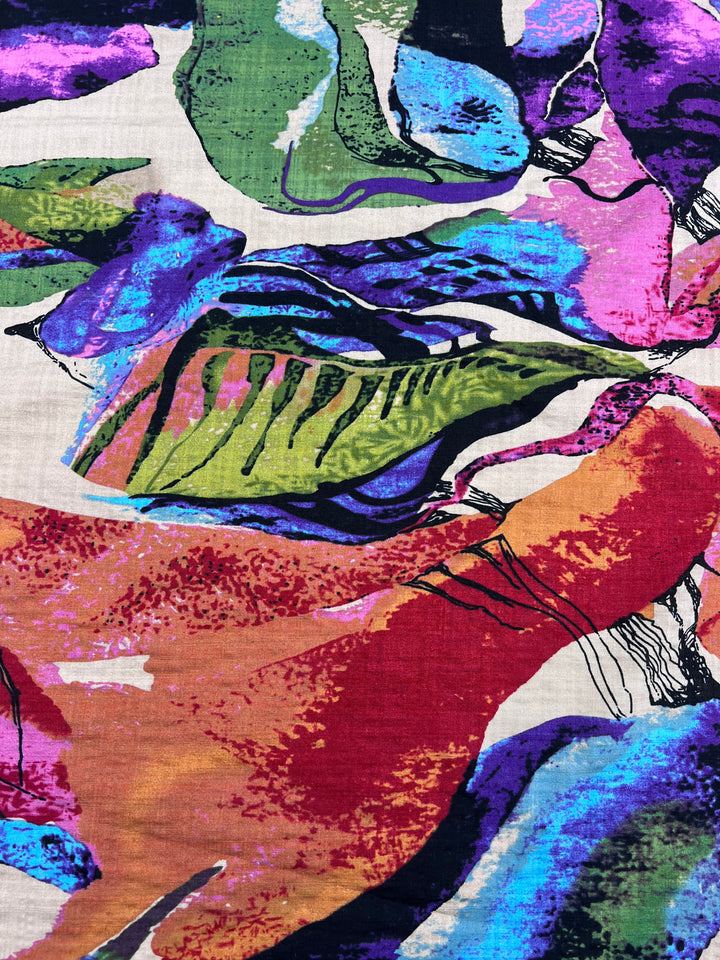 The Super Cheap Fabrics Printed Linen - Aurora - 137cm showcases vibrant swirls and shapes in blue, green, pink, orange, and purple with bold black outlines. Its textured appearance makes it a versatile choice for garment creations.