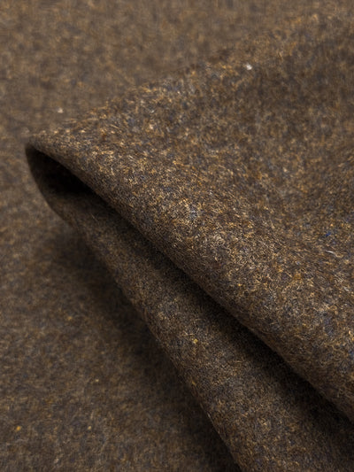 A close-up of Melton Wool - Multi Marle from Super Cheap Fabrics shows a folded piece of brown, mottled, textured fabric. It features heavy-weight wool with color variations and a plush, soft look, ideal for skirts made from multi marle materials.