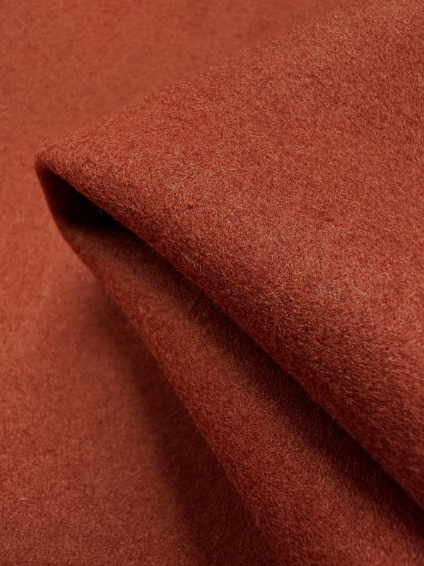 A close-up of the Wool Cashmere - Winery fabric by Super Cheap Fabrics, measuring 150cm, shows cozy, rust-colored fibers with a soft texture, revealing luxurious draping and softness.