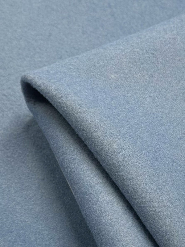 Close-up of a folded piece of Wool Cashmere - Faded Denim by Super Cheap Fabrics, 150cm wide, highlighting its cozy, plush texture and luxurious softness.