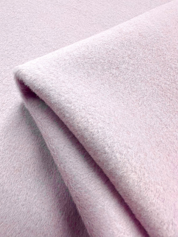 Close-up of Super Cheap Fabrics' Wool Cashmere in Lavender Fog (154cm), folded neatly. Its soft texture and cozy, fuzzy appearance suggest warmth and comfort with luxurious softness.