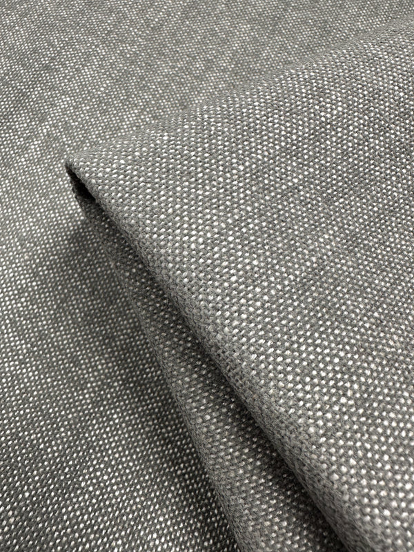 Close-up of the Dresden Warm Silver fabric by Super Cheap Fabrics, folded to reveal a thick, neatly layered structure with a simplistic design in a basket weave upholstery pattern.