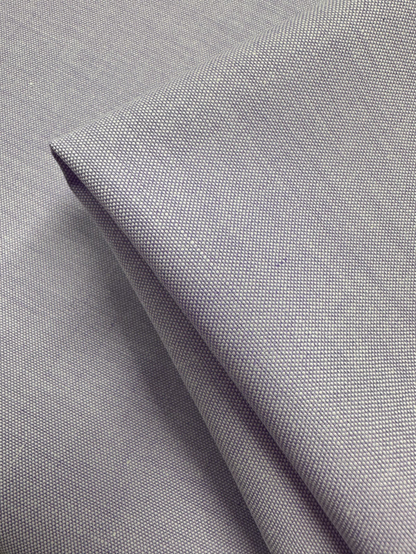 Close-up of folded Oxford Cotton in Baby Lavender (146cm) by Super Cheap Fabrics. The fine, tightly woven cotton appears smooth and slightly reflective with neat folds and clean edges.