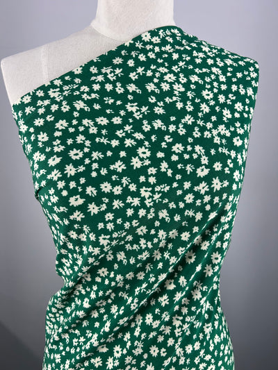 Rayon fabric in a green daisy print