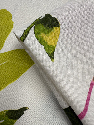 Close-up of Super Cheap Fabrics' Pure Linen - Spring Bloomscape - 150cm, showing its breathable texture and hand-painted look with green, yellow, and pink leafy patterns for a fresh spring feel.