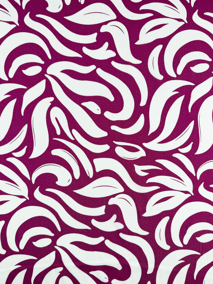 Designer Rayon - Wild Bloom Fizz by Super Cheap Fabrics features bold magenta with white organic, leaf-like shapes and vibrant swirling prints. Width: 145cm. Perfect for versatile, eye-catching creations.