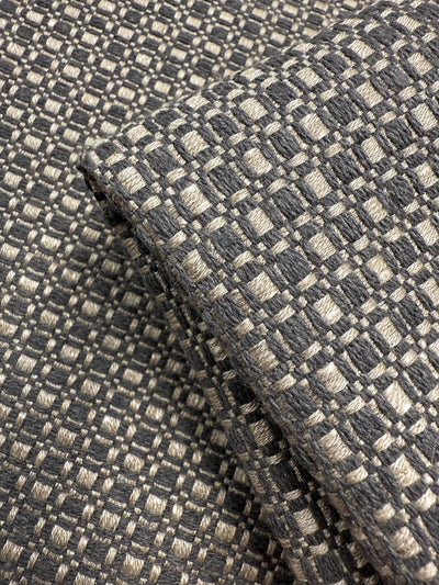 Close-up of Super Cheap Fabrics’ Upholstery Basketweave - Aria Steel (144cm): premium Australian fabric with a soft, thick feel and a textured checkerboard pattern in gray and beige featuring a raised, grid-like design.