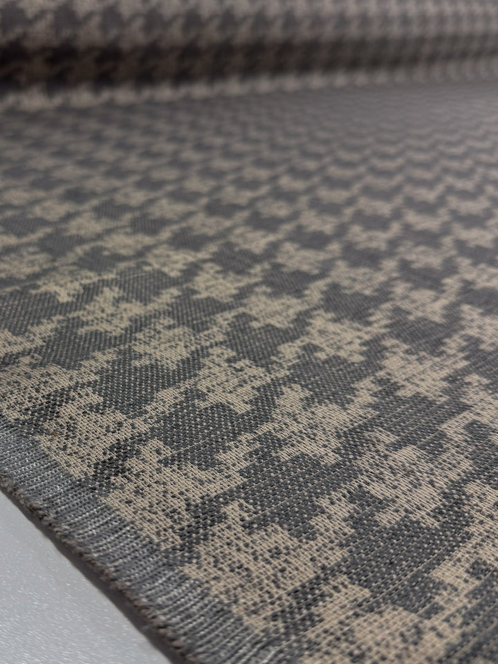 Close-up of Super Cheap Fabrics' Upholstery Jacquard - Westwood Grey Dusk (154cm), highlighting its detailed texture and weave. Rolled out with the selvage edge visible—ideal for luxurious upholstery projects.