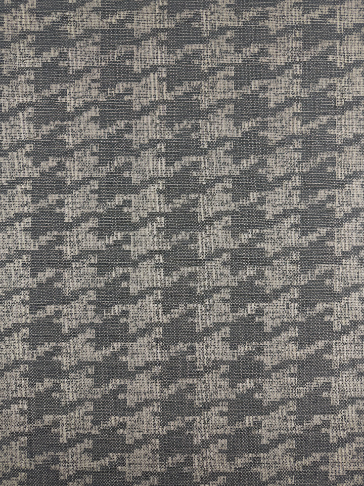 A close-up of Upholstery Jacquard - Westwood Grey Dusk (154cm) by Super Cheap Fabrics shows a repeating abstract houndstooth pattern in light and dark gray, crafted from premium Australian fabric for high-end upholstery.