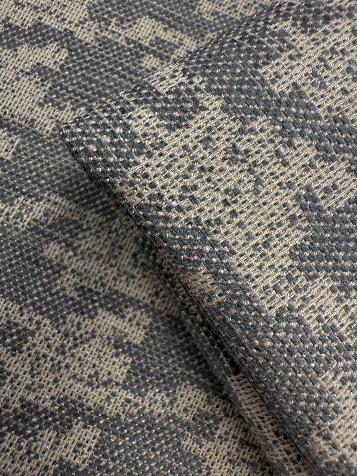 Close-up of Super Cheap Fabrics' Upholstery Jacquard - Westwood Grey Dusk (154cm), showing its gray and beige geometric pattern and intricate weave, ideal for premium upholstery projects.