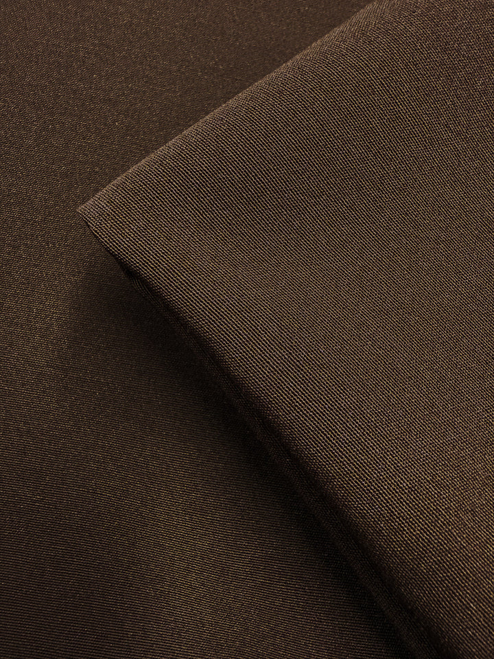 A close-up of two pieces of Super Cheap Fabrics' Cotton Bengaline - Mocha Earth (150cm), showcasing their fine, smooth texture with one fabric layered diagonally over the other.