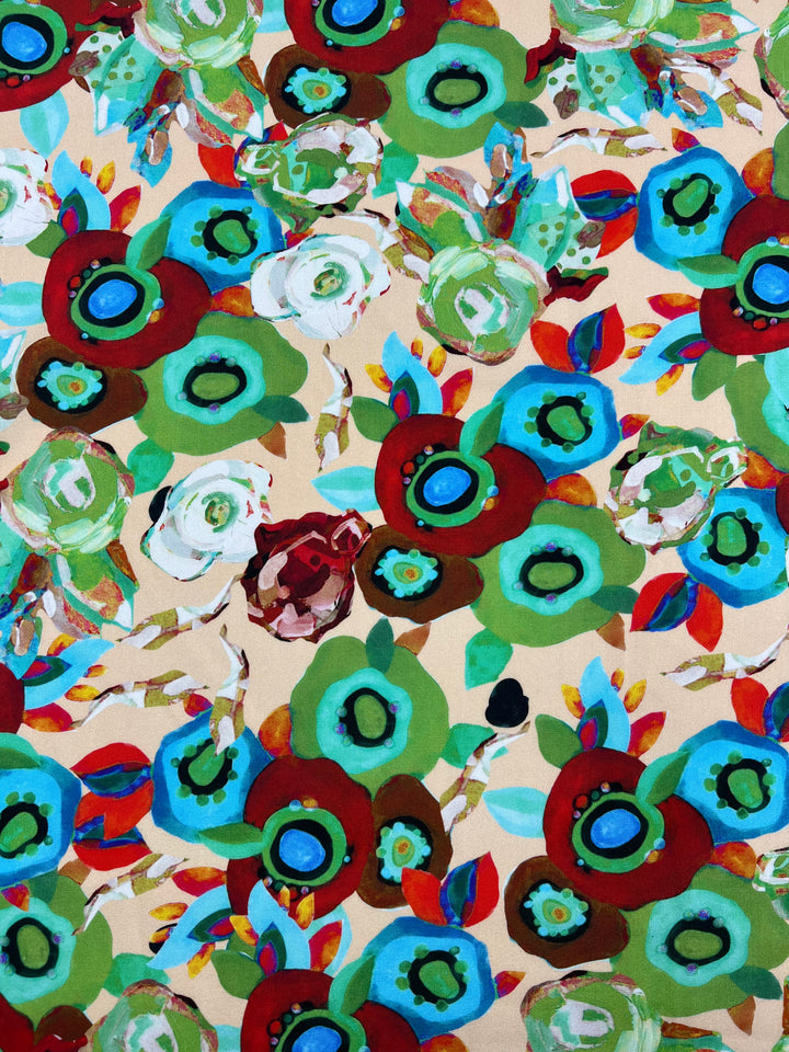 An abstract floral pattern featuring bright colors and bold shapes, the Designer Rayon - Eloise - 145cm fabric from Super Cheap Fabrics showcases vibrant prints with various flowers sporting petals in shades of blue, green, red, and white against a beige background. Some flowers have circular centers, while multicolored leaves are scattered throughout.