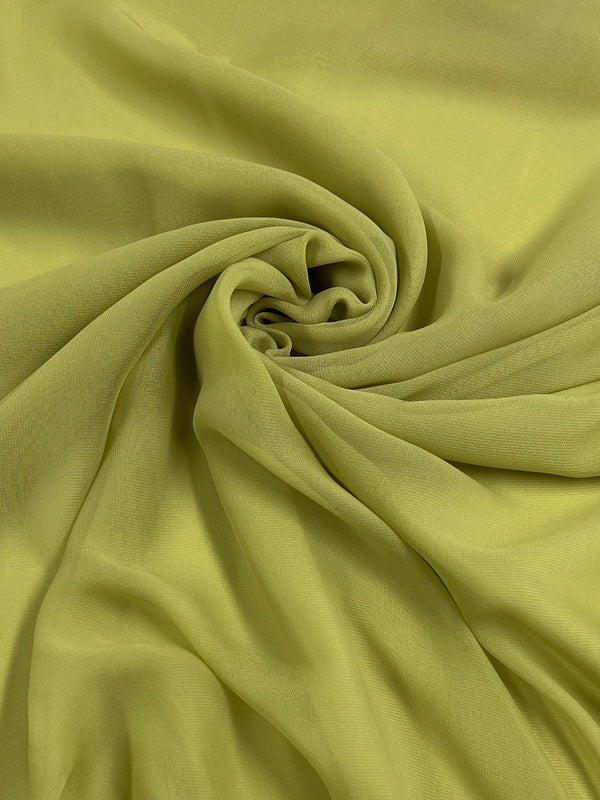 A swirl of Hi-Multi Chiffon fabric in Linden Green from Super Cheap Fabrics, featuring a spiral pattern with soft folds and a smooth, lightweight texture reminiscent of sheer floaty tops.