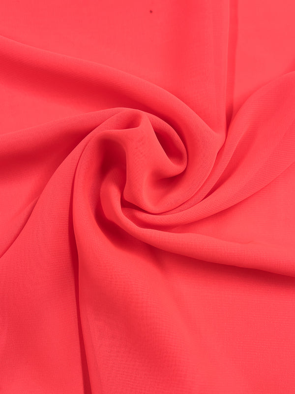 A close-up of the vibrant Fluoro Pink Hi-Multi Chiffon by Super Cheap Fabrics showcases its sheer, smooth texture elegantly twisted in the center, creating soft, flowing folds reminiscent of floaty tops.