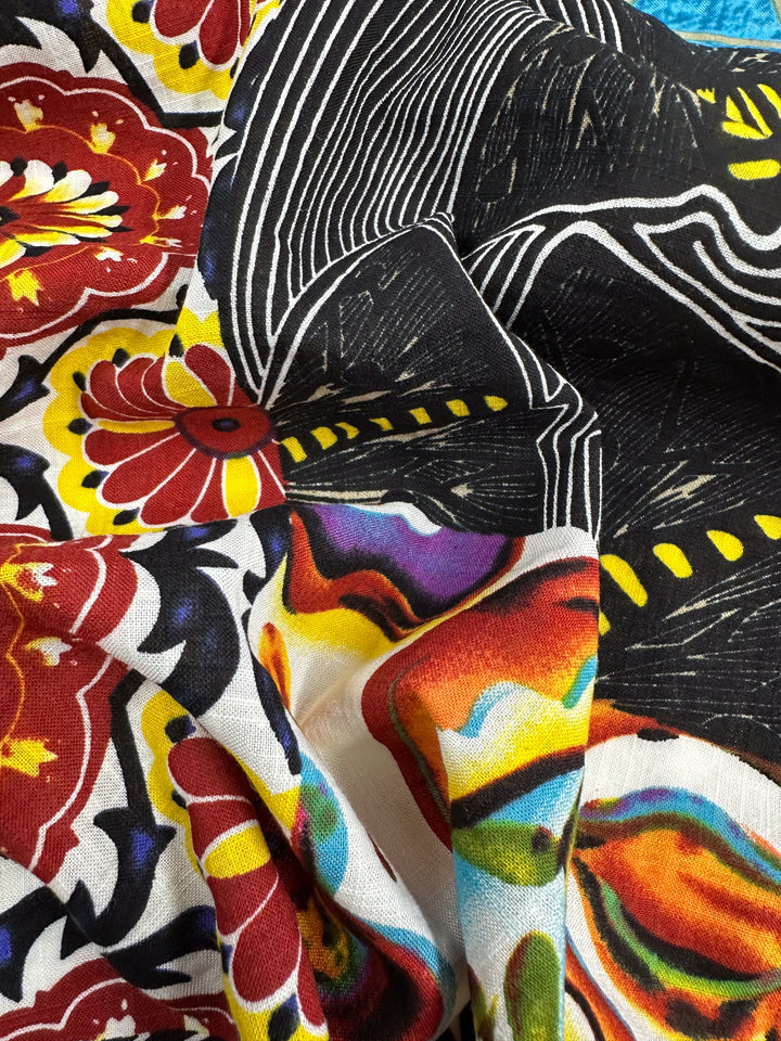 The Linen Blend - Wonky Patchwork by Super Cheap Fabrics is a vibrant, lightweight fabric with eclectic patterns featuring red and yellow floral designs, black-and-white geometric lines, and multicolored abstract shapes. Its vivid textures and colors are perfect for versatile use and creating striking visuals.