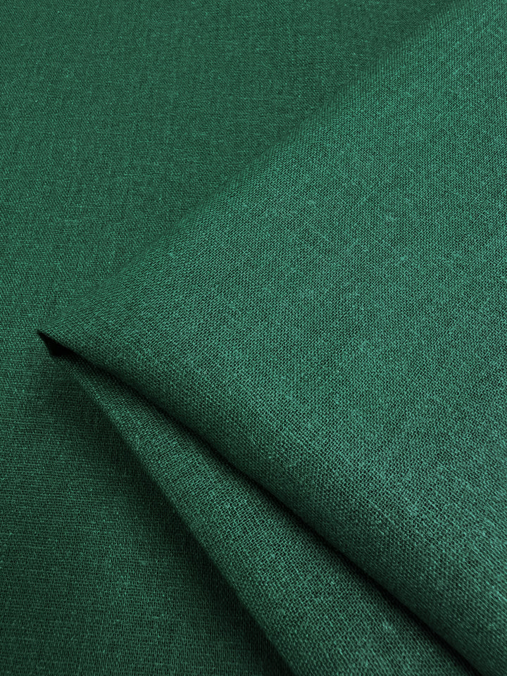 Close-up of folded aventurine Premium Linen Cotton fabric, featuring a subtle textured pattern, from Super Cheap Fabrics.