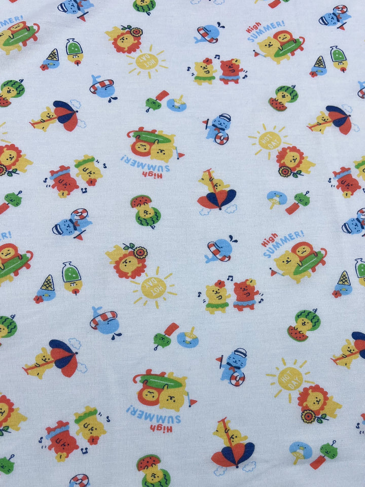 The "Summer Times" printed jersey from Super Cheap Fabrics showcases vibrant cartoon illustrations of animals like lions, turtles, and ducks enjoying summer activities with beach balls and umbrellas. The energetic pattern is displayed on a lightweight 180cm fabric, featuring "Hi! SUMMER!" text throughout, making it perfect for crafting a fun stretch fabric experience.