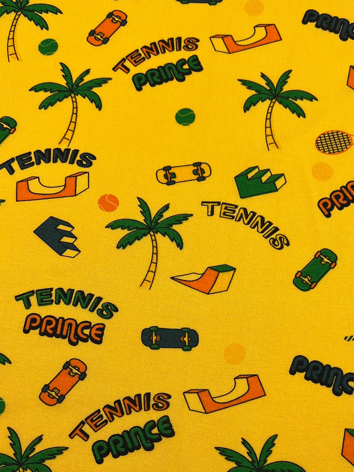 Introducing the Printed Jersey - Tennis - 160cm by Super Cheap Fabrics: This dynamic design showcases palm trees, skateboards, and abstract shapes on a lively yellow backdrop. The pattern features the words "TENNIS" and "PRINCE" interspersed with images of tennis balls and racquets. Made from a two-way stretch, medium-weight fabric, this jersey is perfect for vibrant creations.