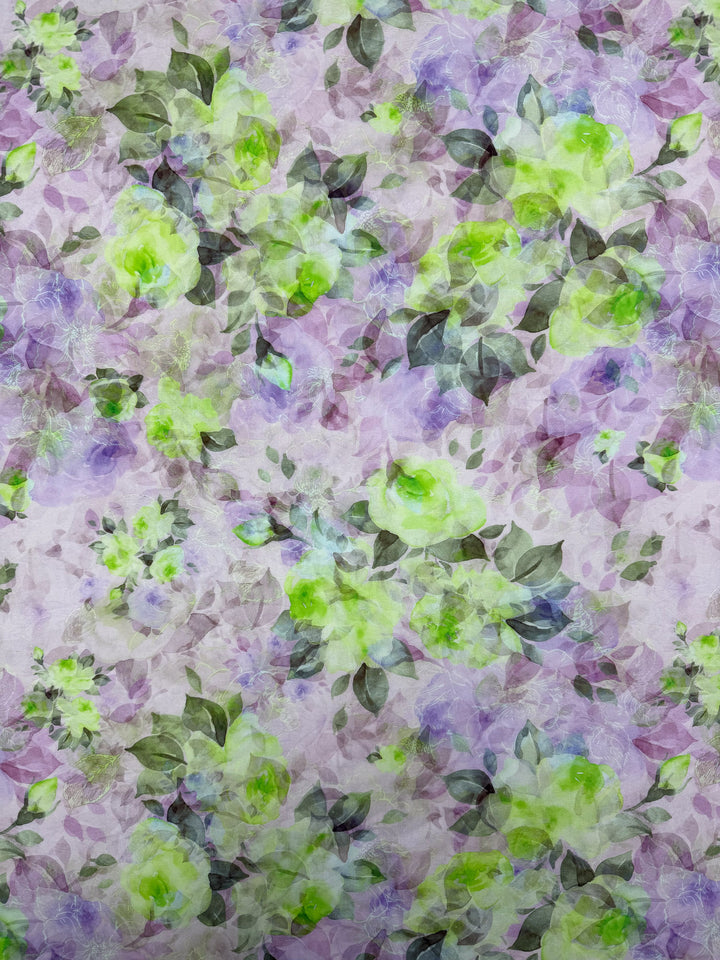 Designer Cotton - Lime Smoke by Super Cheap Fabrics features a delicate floral watercolor pattern in light green, purple, and lavender with green and gray leaves on a pastel background. Ideal for quilting or lightweight cotton projects. Width: 145cm.