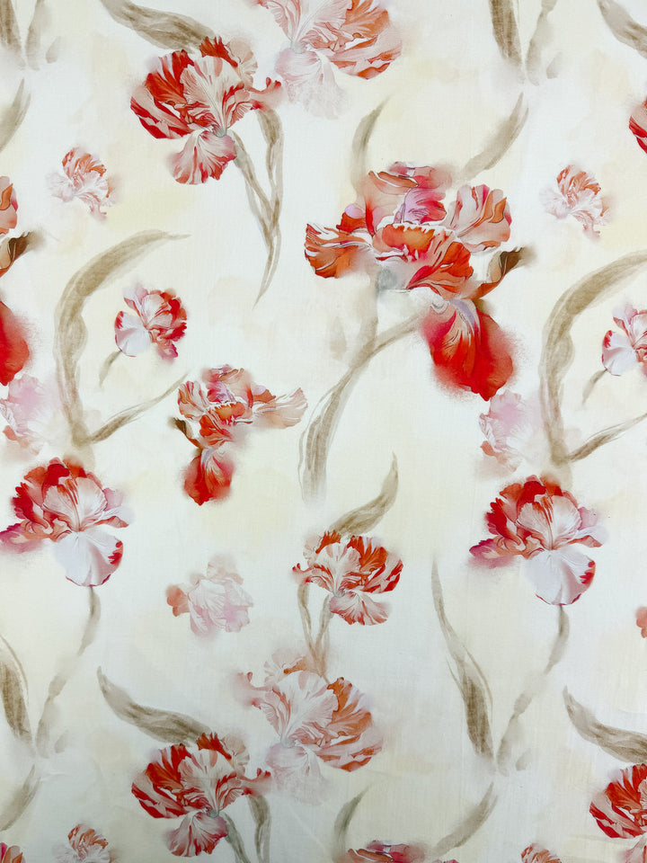 Super Cheap Fabrics’ Designer Cotton - Painted Petal - 145cm is a lightweight cotton fabric with delicate, hand-painted red and pink watercolor flowers and green leaves on a light cream background in a soft, floral pattern.