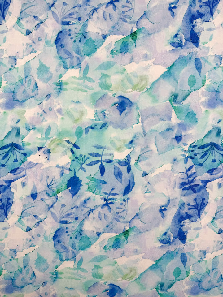 Designer Cotton - Oceans by Super Cheap Fabrics features overlapping blue and green leaves with soft brush strokes on lightweight cotton (145cm), perfect for sewing with a cool, calming botanical look.