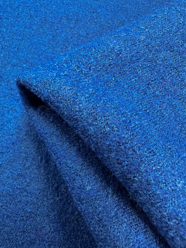 Close-up of Super Cheap Fabrics' Boiled Wool in Lapis Blue, 150cm wide. This vibrant blue wool-viscose blend is elegantly folded, showcasing its heavy weight, soft texture, and intricate weave pattern.