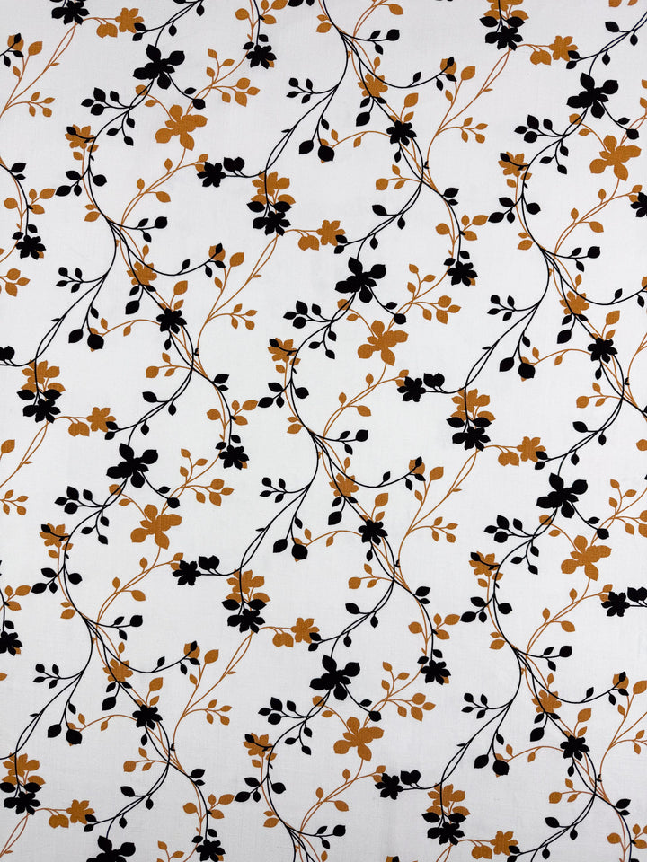 Bamboo Rayon - Vine Whisper by Super Cheap Fabrics is a white, lightweight 150cm fabric with black and mustard floral vines. Elegant, beginner-friendly, and ideal for many projects.
