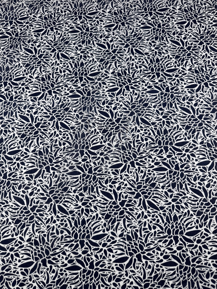The Cotton Voile - Lotus - 147cm by Super Cheap Fabrics features an intricate black and white floral pattern on voile. With densely packed flowers and leaves, it's perfect for creating detailed designs for lightweight, warm-weather clothing.