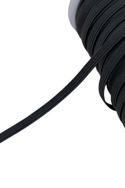 A close-up image of a spool of Super Cheap Fabrics' 6mm Elastic - Black. The cord is tightly wound around the spool, with a single strand extending out. The elastic appears smooth and flexible. The background is plain white, highlighting the texture and details of the cord's metreage.